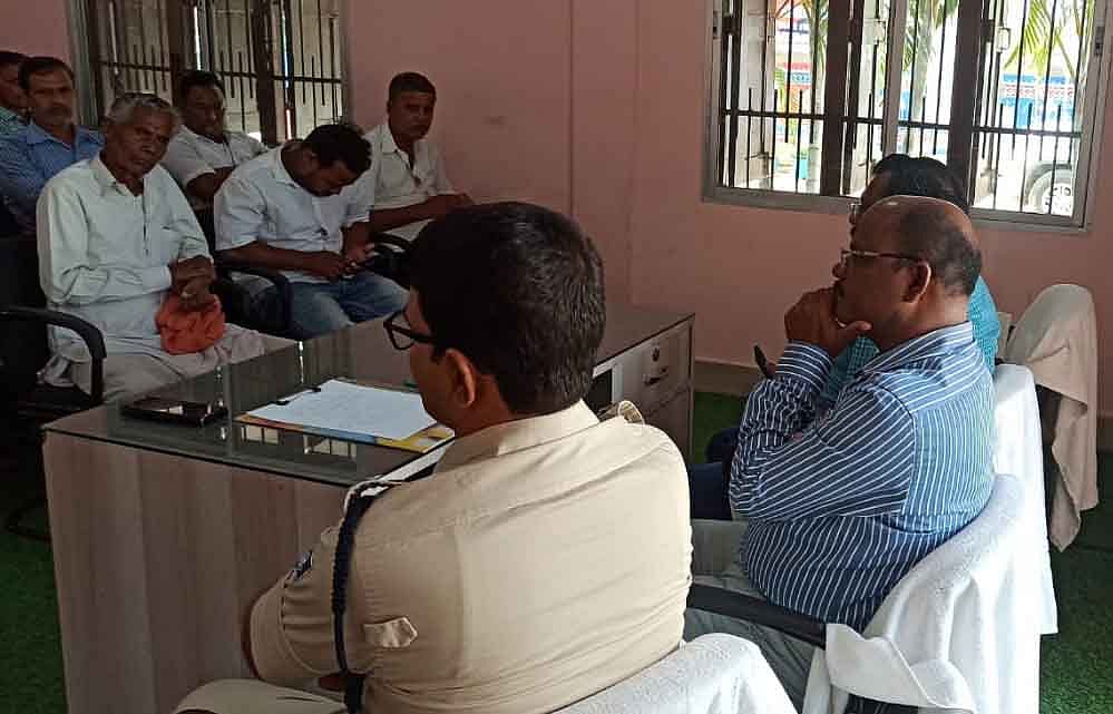 Local Dalit family and upper caste people talking with the local police