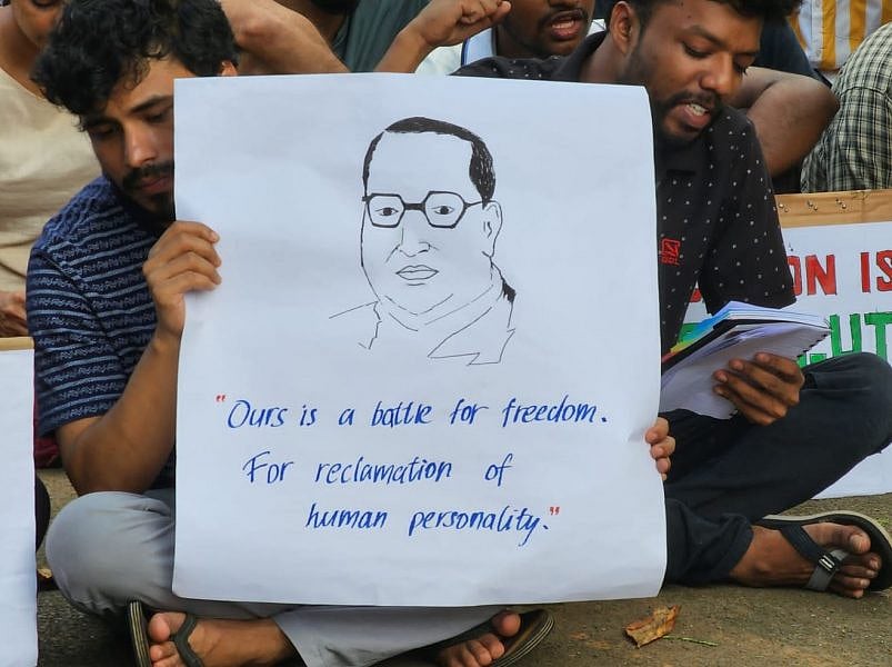 Student with Baba Saheb's sketch at the dharna site