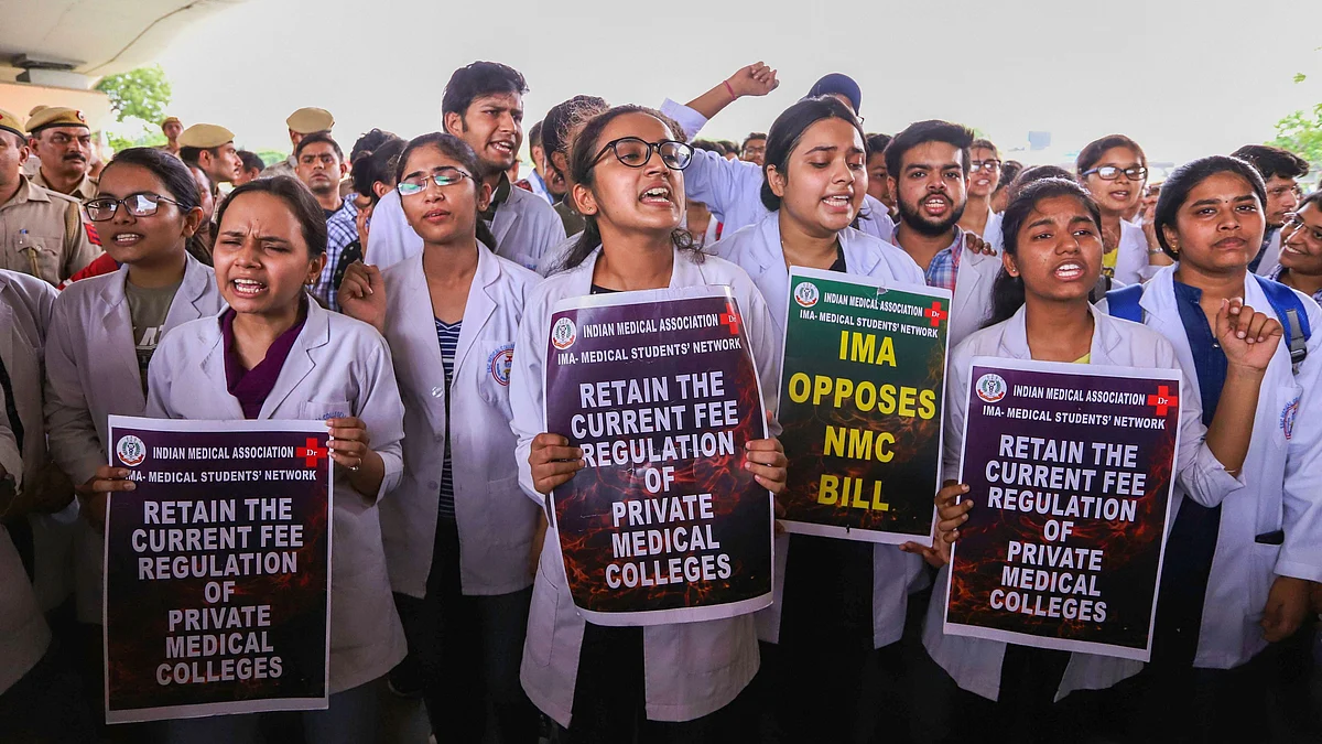 Doctors and medical students of AIIMS display placards during a strike to protest the introduction of the National Medical Commission (NMC) Bill in the Rajya Sabha, in New Delhi.