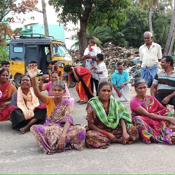 குப்பைகளை அகற்றக்கோரி ரோட்டில் அமர்ந்து போராட்டம்