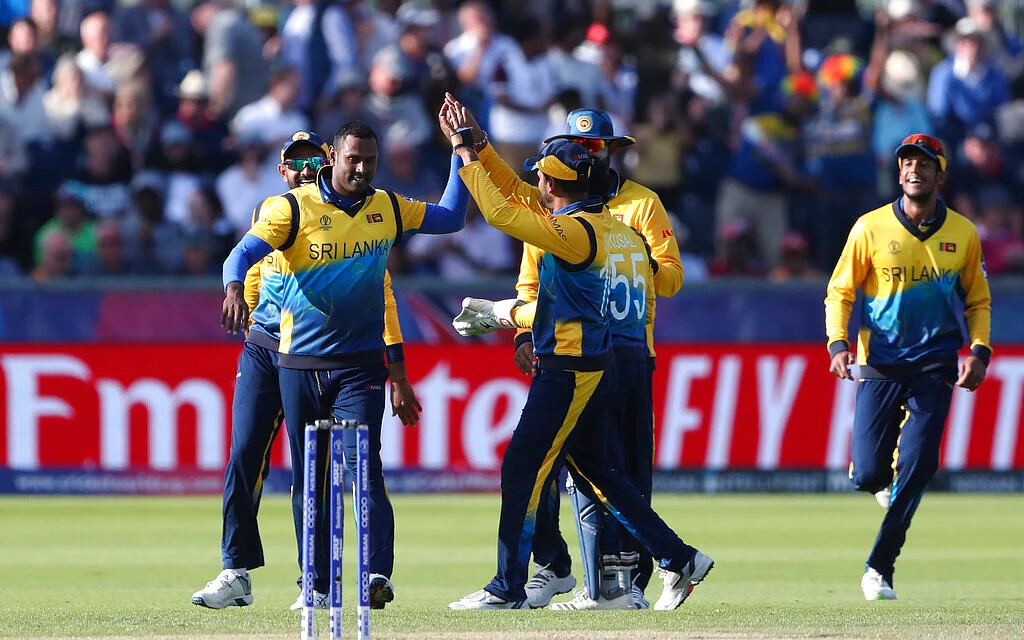 Sri Lanka's bowler Angelo Mathews, left, celebrates with teammates after dismissing West Indies' batsman Nicholas Pooran for 118 runs.