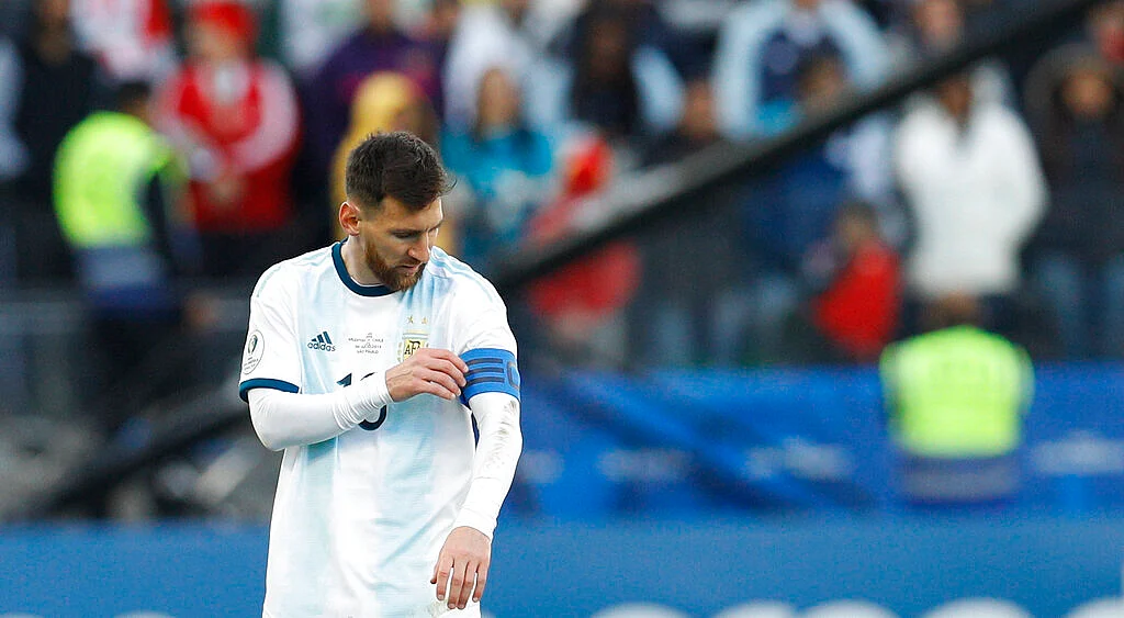 Argentina's Lionel Messi touches his captain band during Copa America third-place soccer match against Chile.