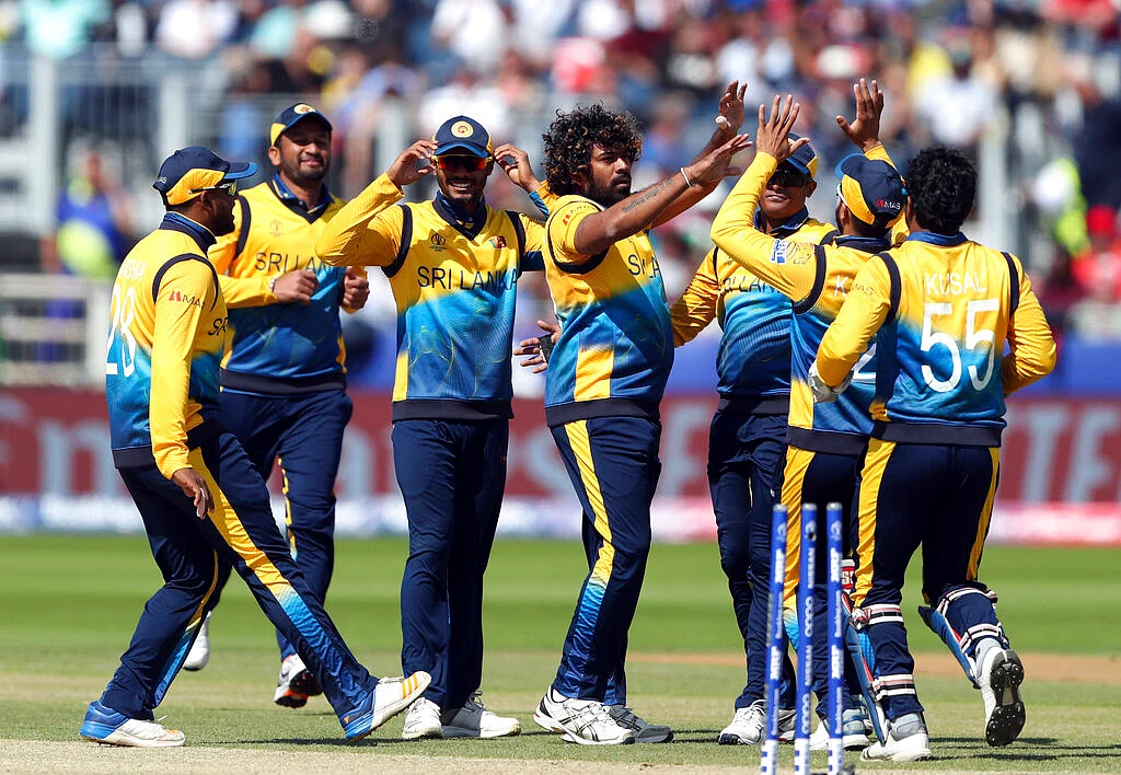 Sri Lanka's bowler Lasith Malinga, middle, with teammates celebrates after bowling West Indies' batsman Shai Hope.