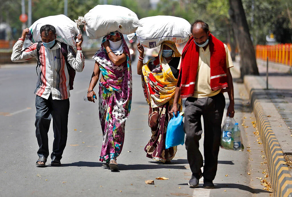 A group of daily wage laborers walk to return to their villages in Prayagraj, India.