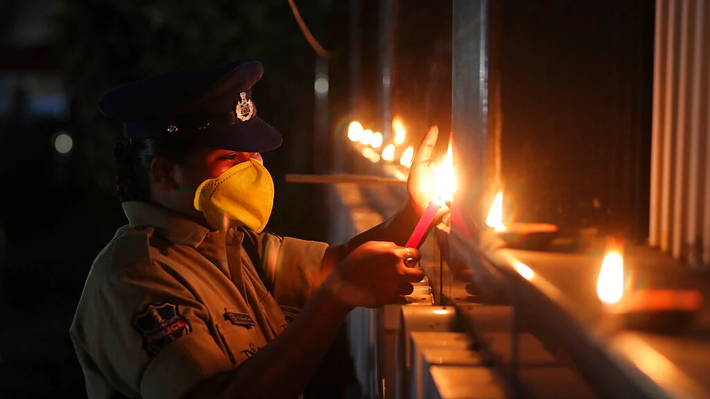 An Indian policewoman lights lamps in Hyderabad.