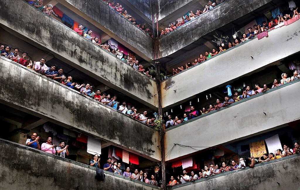 People clap from balconies in show of appreciation to health care workers at a Chawl in Mumbai, India