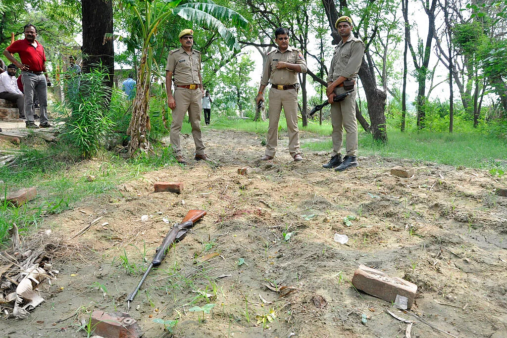 Policemen inspect the scene of an ambush in Kanpur, India, Friday, July 3, 2020.
