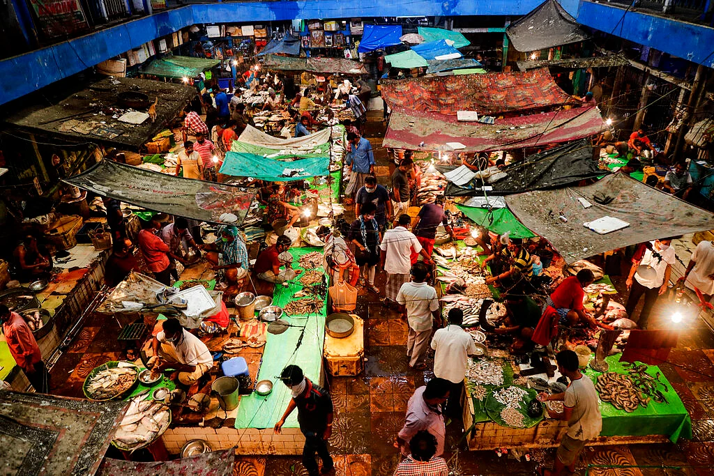 People shop for fish at a market in Kolkata, India