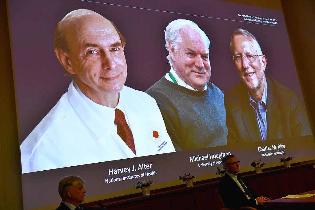 The 2020 Nobel laureates in Physiology or Medicine are announced during a news conference at the Karolinska Institute in Stockholm, Sweden, Monday Oct. 5, 2020. The prize has been awarded jointly to Harvey J. Alter, left on screen, Michael Houghton, center, and Charles M. Rice for the discovery of the Hepatitis C virus.