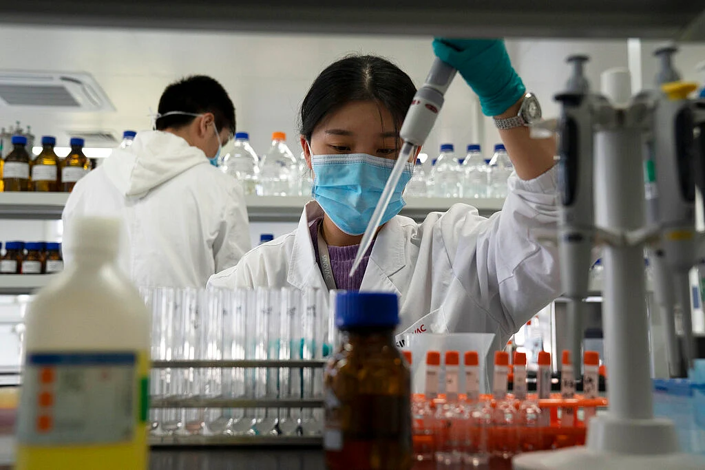 file photo, an employee of SinoVac works in a lab at a factory producing its SARS-CoV-2 vaccine for COVID-19 named CoronaVac in Beijing.