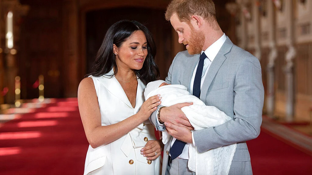 Harry and Meghan holding their son Archie