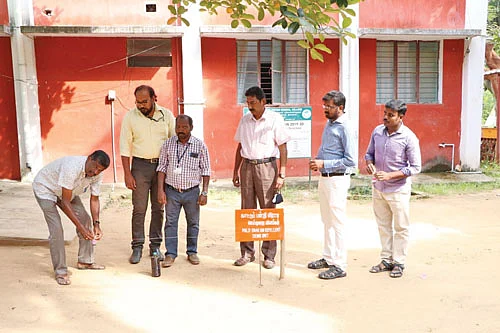 இரண்டு குச்சிகளுக்கிடையே சிறிய டப்பாவில் மருந்தைத் தொங்க விடுதல்