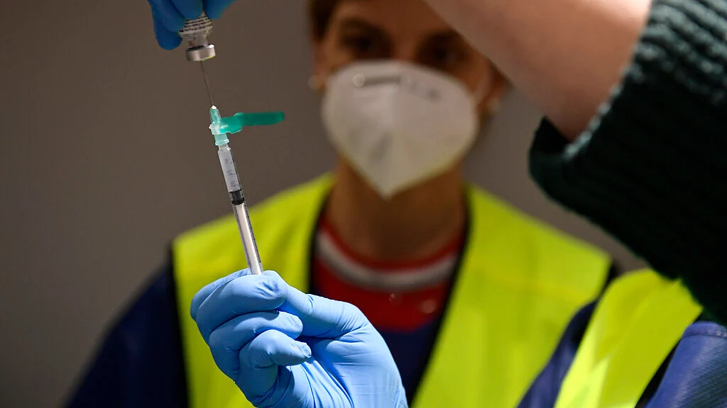 A health worker prepares a Pfizer coronavirus vaccine