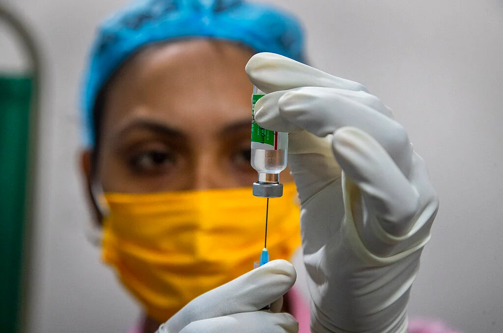 A health worker prepares COVID-19 vaccine at a hospital in Gauhati, India