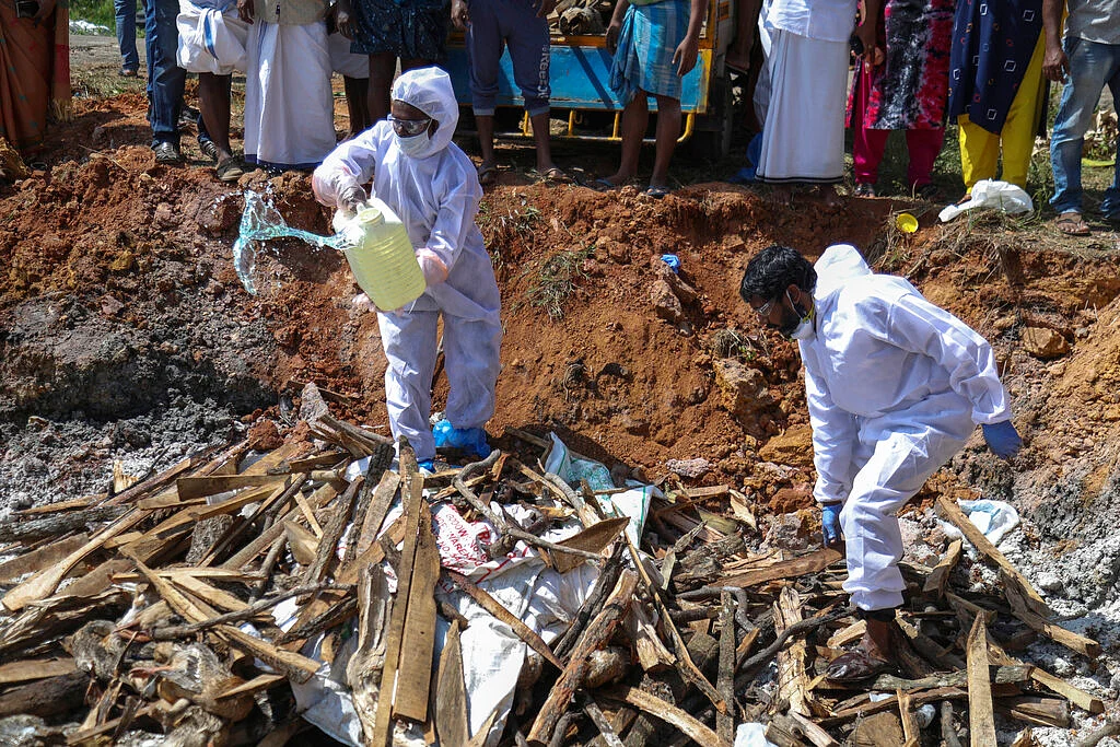 Health workers in protective suits prepare to set fire after culling ducks following the detection of H5N8 strain of bird flu among domestic birds in Alappuzha district, Kerala