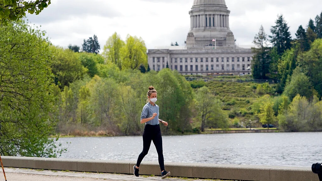 A person wears a mask while jogging