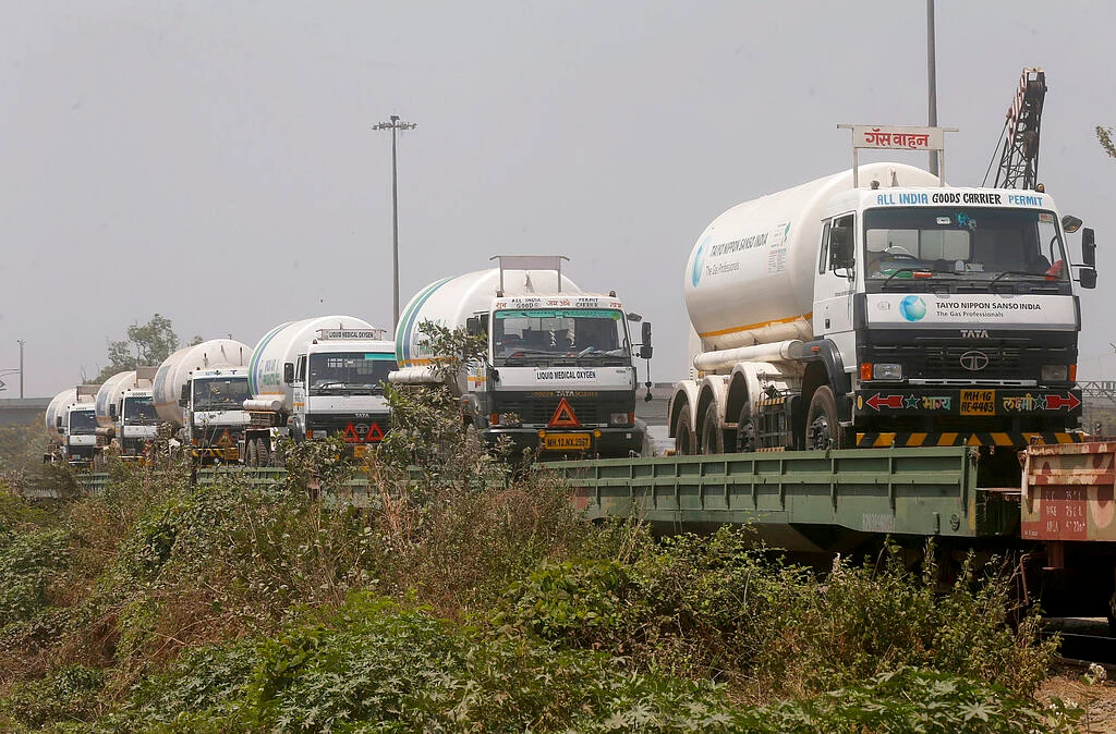 Empty tankers are loaded on a train wagon at the Kalamboli goods yard in Navi Mumbai, Maharashtra state, India, before they are transported to collect liquid medical oxygen from other states