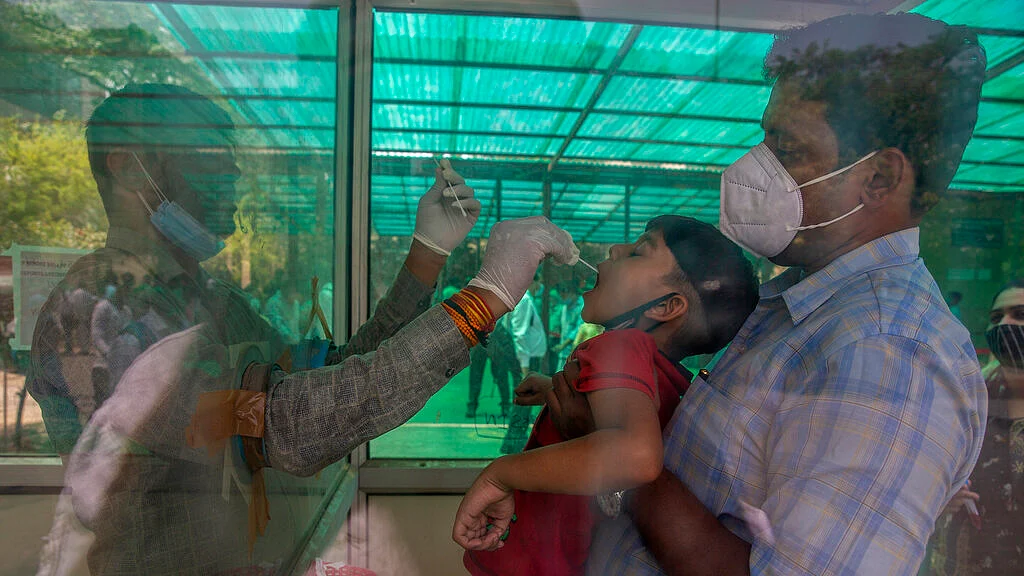 A health worker takes a swab sample