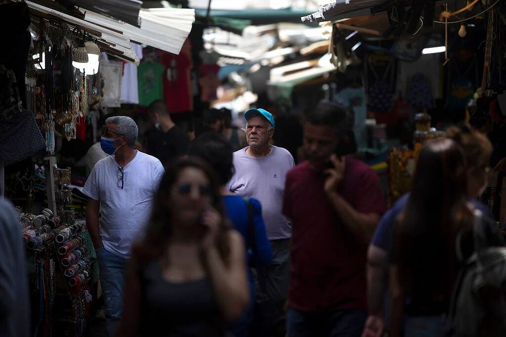 Israelis walk in a market in Tel Aviv, Israel, Sunday, April 18, 2021.