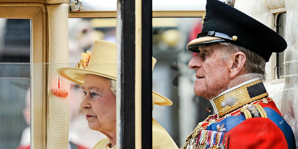 Britain's Prince Philip sits beside Queen Elizabeth II