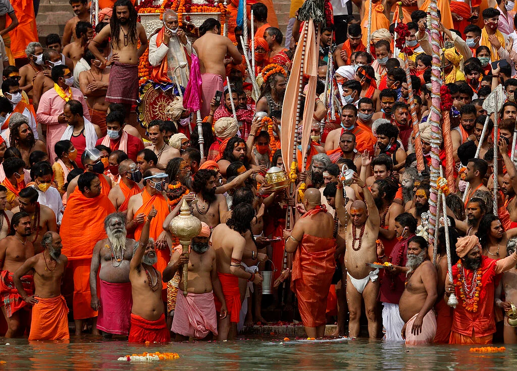 Hindu devotees gather to take holy dips in the Ganges River during Kumbh Mela