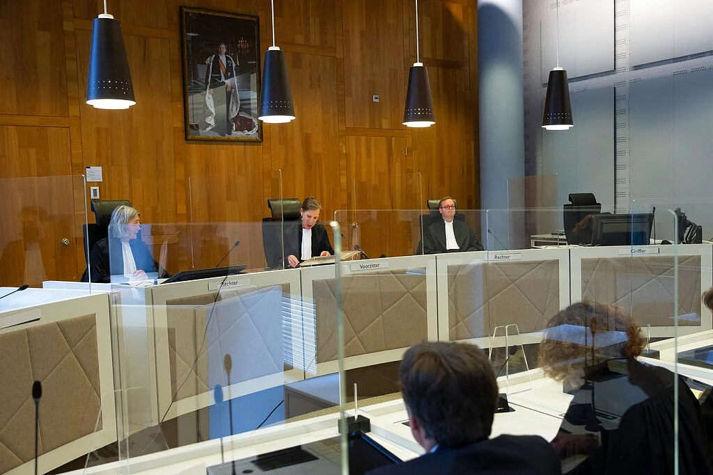 Presiding judge Larissa Alwin, center, reads the verdict as judges Irene Kroft, left, and M.L. Harmsen, right, attend, in the court case of Milieudefensie, the Dutch arm of the Friends of the Earth environmental organization, against Shell in The Hague, Netherlands.