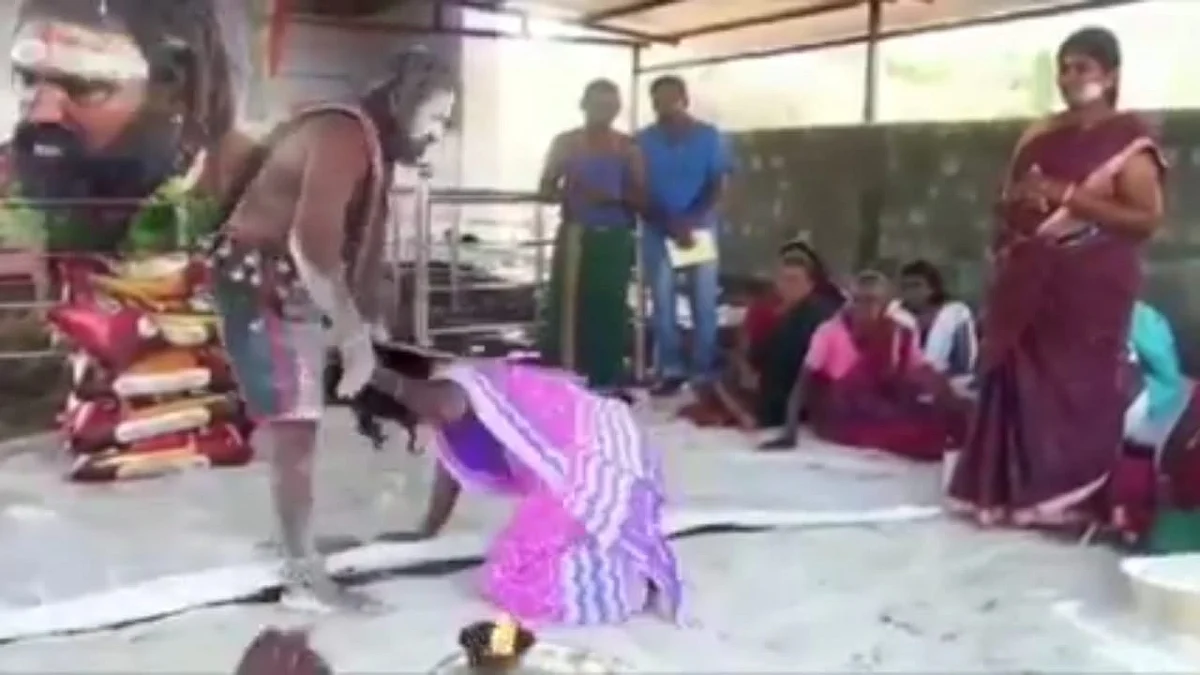 பெண்ணை அடிக்கும் சாமியார்