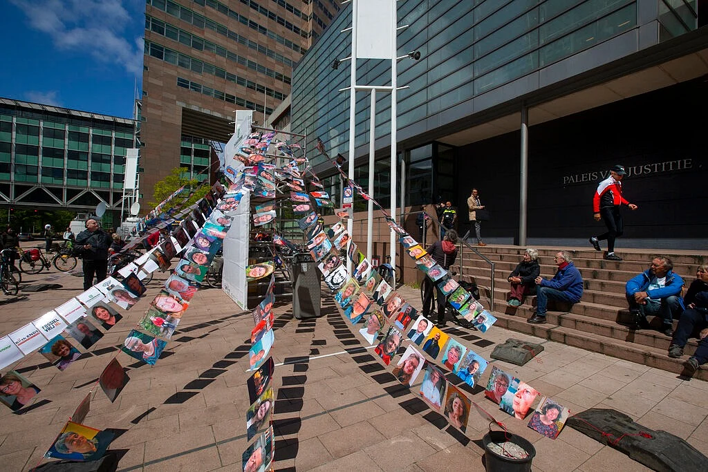Pictures of plaintiffs fly outside the court where Milieudefensie, the Dutch arm of the Friends of the Earth environmental organization, took Shell to court, in The Hague, Netherlands.