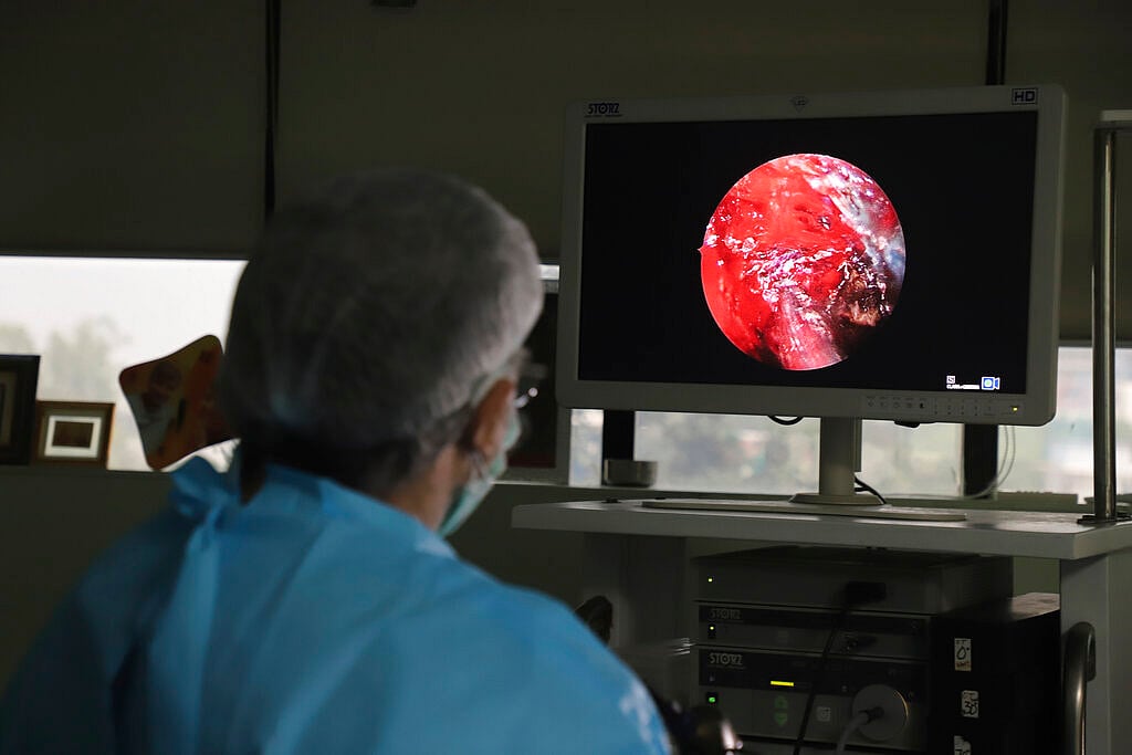 Indian doctor performs extended functional endoscopic sinus surgery on a person suffering from mucormycosis