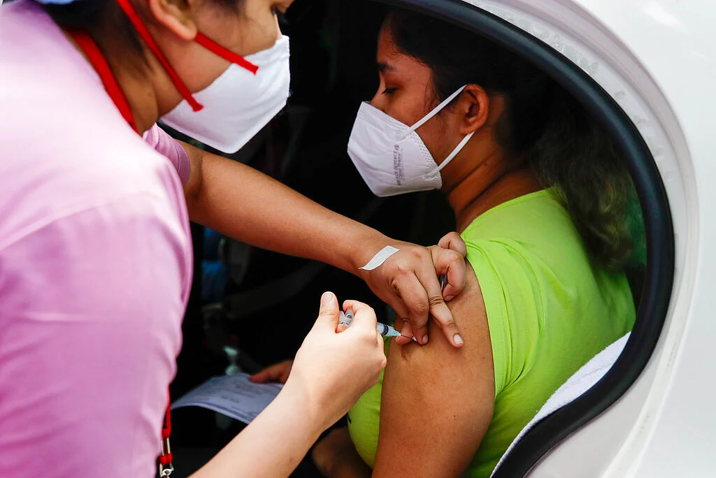 a health worker administers Covishield