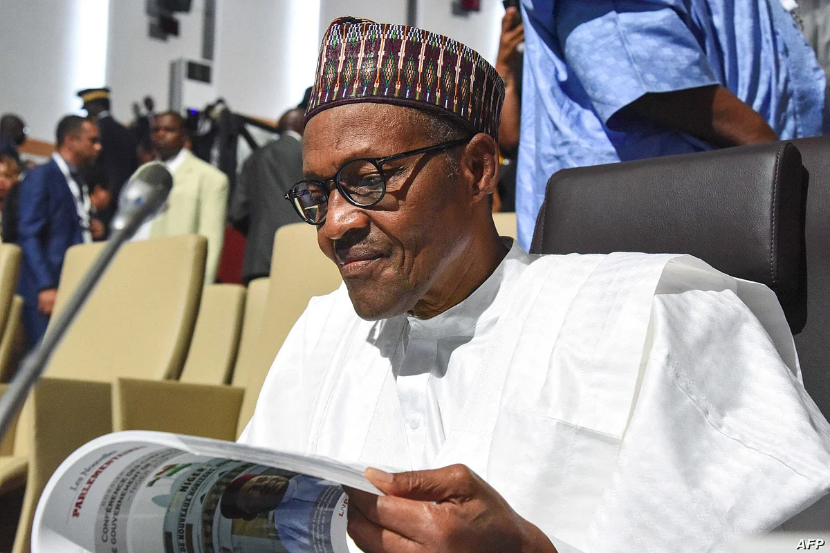 Nigerian president Muhammadu Buhari reads a document during the African Union summit at the palais des Congres in Niamey, on July 7, 2019. - Heads of state meet for an African Union (AU) two-day summit in Niger. (Photo by ISSOUF SANOGO / AFP)
