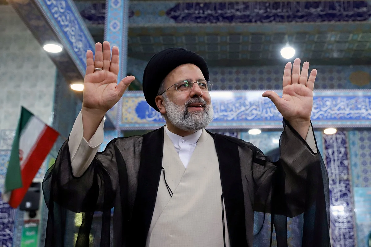 FILE PHOTO: Presidential candidate Ebrahim Raisi gestures after casting his vote during presidential elections at a polling station in Tehran, Iran June 18, 2021. Majid Asgaripour/WANA (West Asia News Agency) via REUTERS