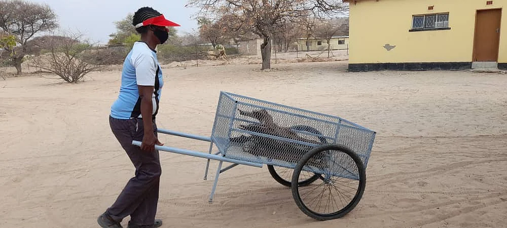 Community member from Mosu Village testing the Majakathata Deep Sand Firewood Carrier (Mosu Village)